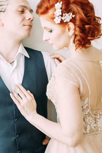 Meeting the newlyweds in the Studio and hotel. Bride and groom with a bouquet.