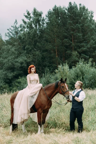 Wedding walk on a horse. Couple walking in nature in the forest.