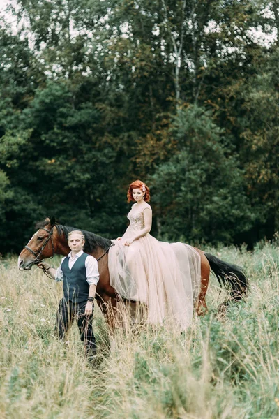 Wedding walk on a horse. Couple walking in nature in the forest.
