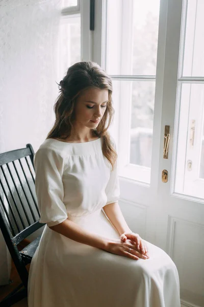 Light wedding photo shoot in the Museum. Beautiful bride in sitting in the Studio.