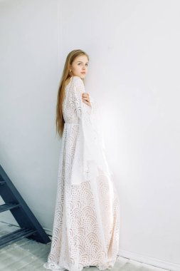 Güzel gelin beyaz minimalist zemin üzerinde. Güzel Sanatlar düğün hazırlıkları.