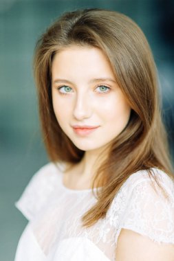 Parlak mavi ve kırmızı zemin üzerine güzel bir gelin portresi. Minimalist beyaz elbise.