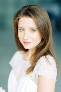 Parlak mavi ve kırmızı zemin üzerine güzel bir gelin portresi. Minimalist beyaz elbise.