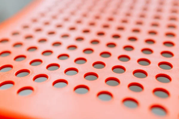 Textura Borrosa Bokeh Fondo Plástico Rojo Con Agujeros — Foto de Stock