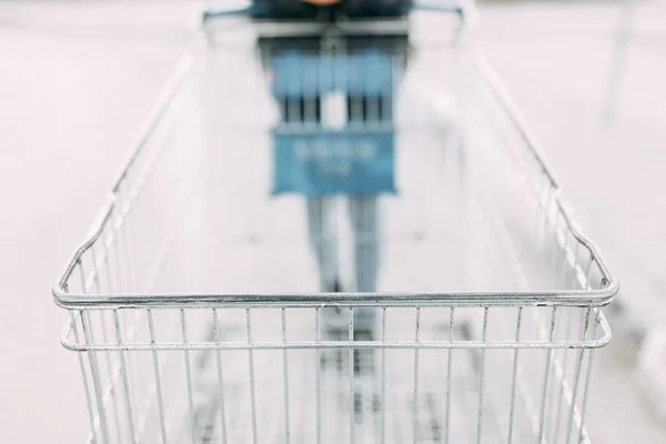 Food basket and the girl's hands. Trolley for shopping products in the supermarket.