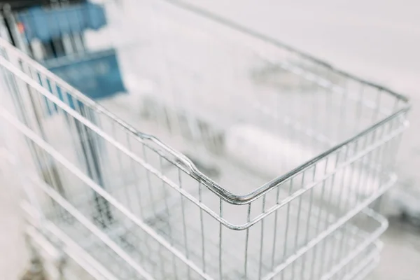 Food basket and the girl's hands. Trolley for shopping products in the supermarket.