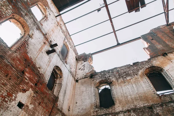 Destroyed historical building as in the war. Old abandoned factory outside.