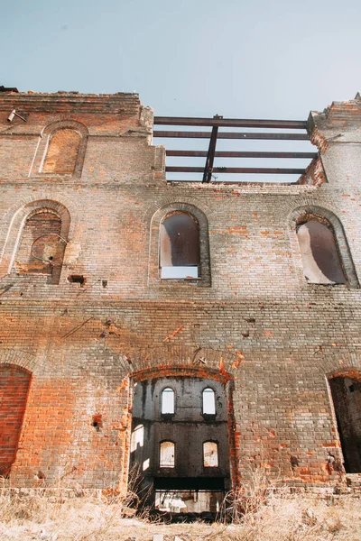 Destroyed historical building as in the war. Old abandoned factory outside.