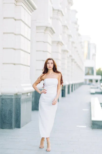 Summer look and white dress. Portraits of an elegant girl with luxury apartments.