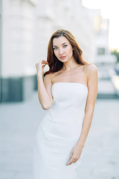 Summer look and white dress. Portraits of an elegant girl with luxury apartments.