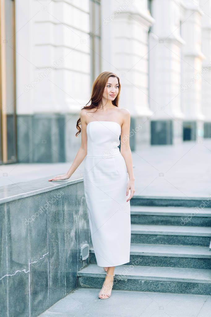  Summer look and white dress. Portraits of an elegant girl with luxury apartments.
