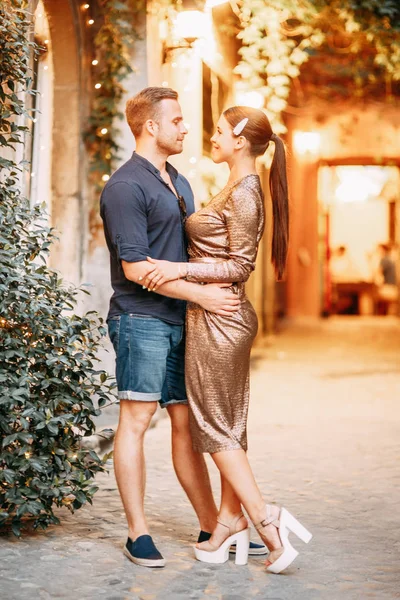 Happy couple at sunset in Italy. Evening summer photo shoot in Rome.