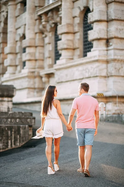 Happy couple at dawn strolling in Italy. Morning summer photo shoot in Rome.