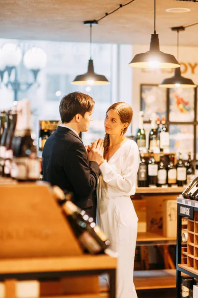 bright emotions in a family photo shoot. happy couple in the interior of a wine bar.