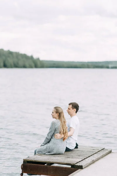 a walk in the woods by the pier. young couple walking on the lake.