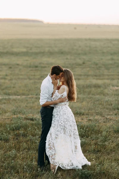 Belo casal na natureza em estilo boho. Casamento em estilo europeu arte fina ao pôr do sol . — Fotografia de Stock