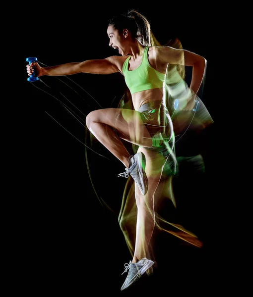 Frau übt Fitness-Übungen isoliert schwarzen Hintergrund Lichtmalerei Effekt — Stockfoto