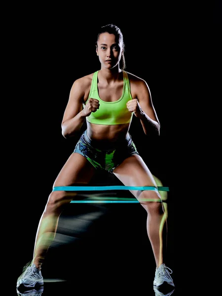 Mujer ejercitando ejercicios de fitness aislado fondo negro efecto lightpainting — Foto de Stock