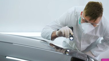 Parlatma ve arabalar, boyama sonra profesyonel master denetler el feneri çizikler, solunum, beyaz lastik eldiven, beyaz önlük, Gözlük, oto servisi.