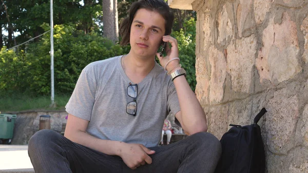 Young Handsome Guy Teenager Sitting Park Writes Message Phone Plastic — Stock Photo, Image