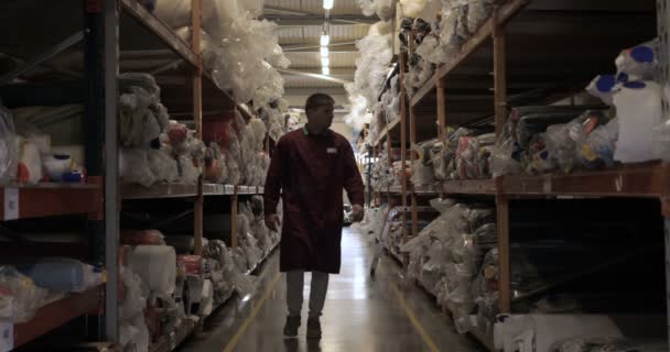 Guy Man Working Clothes Warehouse Work Selects Desired Roll Fabric — Stock Video