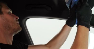 Genç adam (adam) farklı kimya ve farklı araçlar kullanarak, otomobil hizmetleri için hizmet bir çalışma üniforması içinde araba tam bir kuru temizleme yok. Konsept: Oto Oto Servisi, Oto Yıkama, Kuru Temizleme Makineleri.