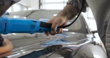 Çalışan siyah bir araba parlatır bir profesyonel, tamir araba, çocuk arabaları, oto yıkama, servis, Profesyonel Araba Seramik İşçi araba camları seramik (koruyucu yağmur kapağı) bir tabaka uygular. Konsept: Nano Koruma, Farklı acces