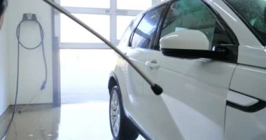 Çalışan siyah bir araba parlatır bir profesyonel, tamir araba, çocuk arabaları, oto yıkama, servis, Profesyonel Araba Seramik İşçi araba camları seramik (koruyucu yağmur kapağı) bir tabaka uygular. Konsept: Nano Koruma, Farklı acces
