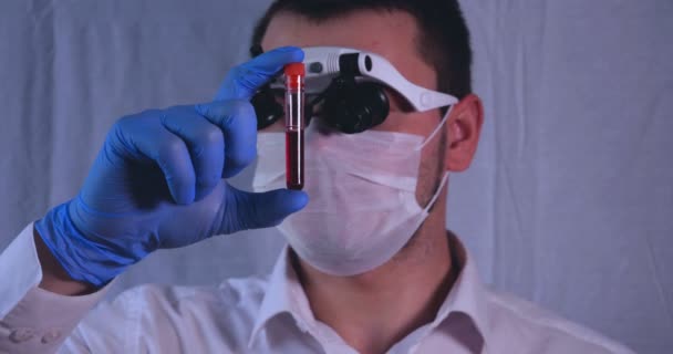ラボ作業は 医師がピペットを保持し 医療用マスクおよび眼鏡において 青色のゴム手袋 Dna 試験管ホルダーに試験管から試験を取る — ストック動画