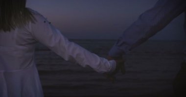 Romantik Çift bir sahilde rahatlatır, yangın kahve yapma. Ve yaşamın keyfini, denizin üzerinde gün batımı hayran. Sahil için inanılmaz seyahat. Arka ışık, Çift yaz tatili gün batımı deniz restoranda şarap içme.
