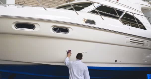 Young Handsome Professional Guy Male Cleaner Washes Yacht Polishing Lining — Stock Video