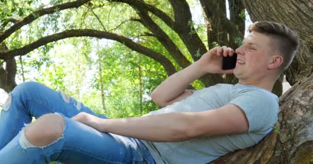 Hombre Usando Una Tableta Debajo Árbol Parque Junto Agua Paisaje — Vídeos de Stock