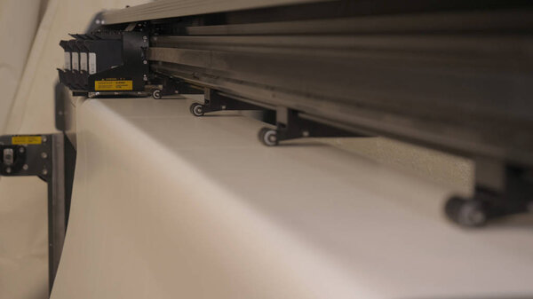 Industrial garment factory, a special Laser Cutting Fabric cuts out certain textile pieces. Concept of: Laser machine, Crosses, Work in a factory, Automatic cutting.