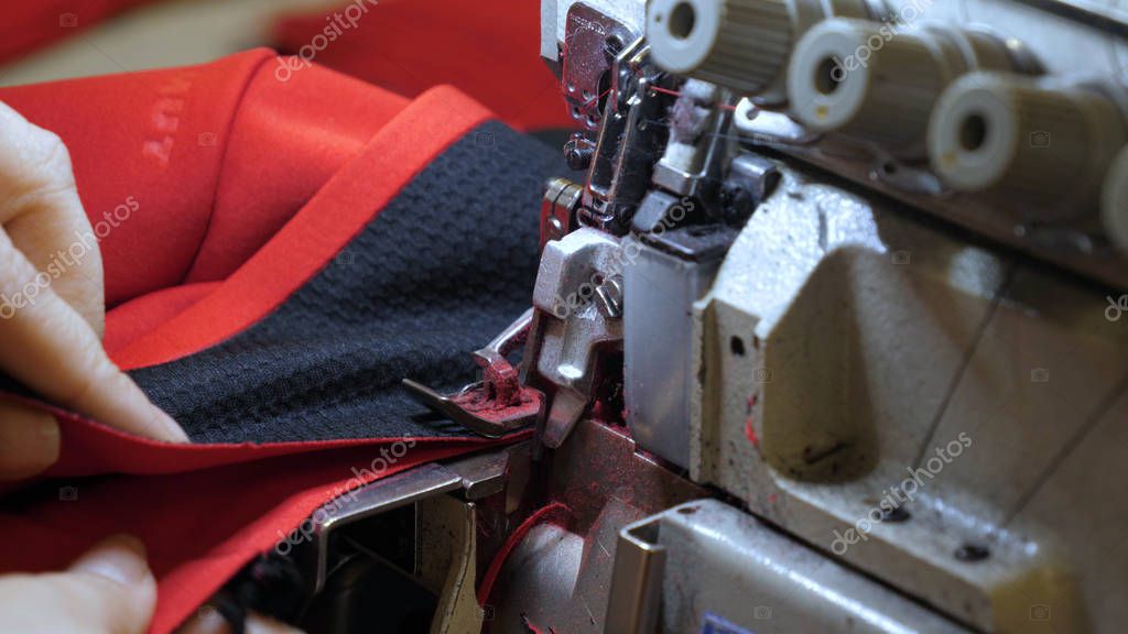 A sewing machine embroiders various companies and engravings. Concept of: Automated work, Sewing machine, Engraving, Thread, Fabric, Needle.