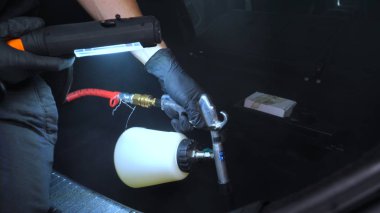 Yakışıklı genç adam, (adam) arabada profesyonel kuru temizleme salonu yapıyor. Konsept: Oto Oto Servisi, Oto Yıkama, Kuru Temizleme Makineleri.