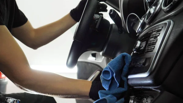 Handsome young guy, (man) doing professional dry cleaning salon in the car. Concept: Auto Car Service, Car Wash, Dry Cleaning Machines.