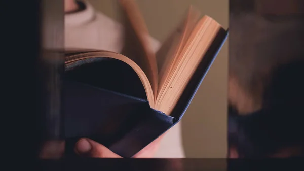 Man takes book from bookcase. Student stands in library and choose book. Guy in smart suit reads near bookcase. Study. Learn, education, research, history