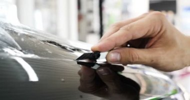 Ön far ve kaputta Ppf montaj işlemine yakın. Ppf, boyayı çizilmelerden ve taş yongalarından koruyan bir Boya Koruma Filmidir. Konsept: Koruma, Koruma, Araba, Yeni, İş.