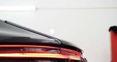 Personel iş yerinde kimyasal koruyucu giysiler giyer. Otomobil endüstrisi. Seramik kaplama ile oto yıkama ve kaplama işi. Vernikleri arabaya püskürtüyor. Konsept: Araba koruyucu, Servis, Shine.