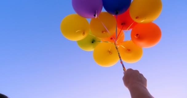 Large Bunch Yellow Helium Ballons Straining Strings Sunny Sky White — Stock Video