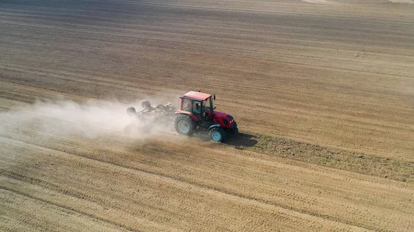 Aerial view drone of harvest field with tractor mows dry grass. Autumn yellow field with a haystack after harvest top view. Harves. Ting in the fields. Stock up