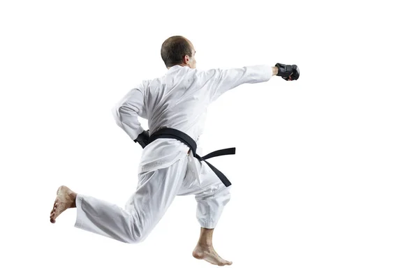 在白色的 Karategi 和黑色的手套 运动员跳动与一只手在跳跃分离 — 图库照片