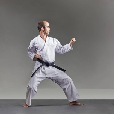 Karategi bir adam gri bir arka plan resmi karate egzersizleri trenler