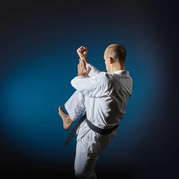 Athlete Performs Formal Karate Exercises Blue Background Gradient — Stock Photo, Image