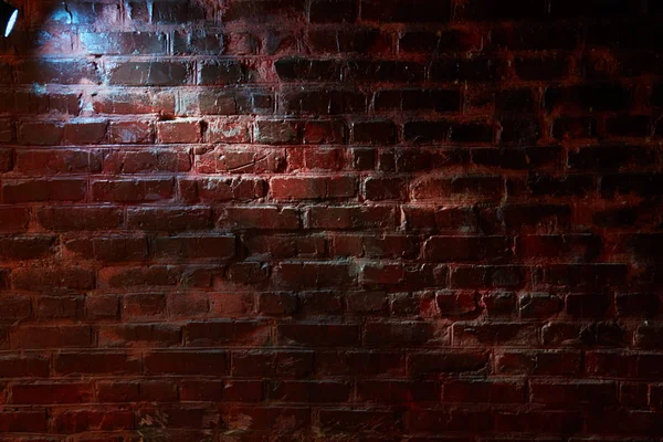 Blue lantern light on a brick wall