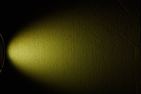 Dark green wide beam of light on a black background