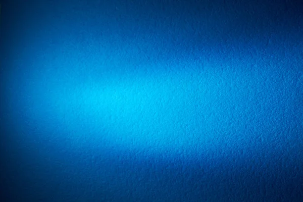 Blue blurred background and light blue wide beam of light