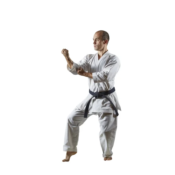 Volwassen Atleet Voert Formele Karate Oefeningen Een Witte Geïsoleerde Achtergrond — Stockfoto