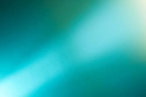 On a turquoise background, a light turquoise intermittent beam of light
