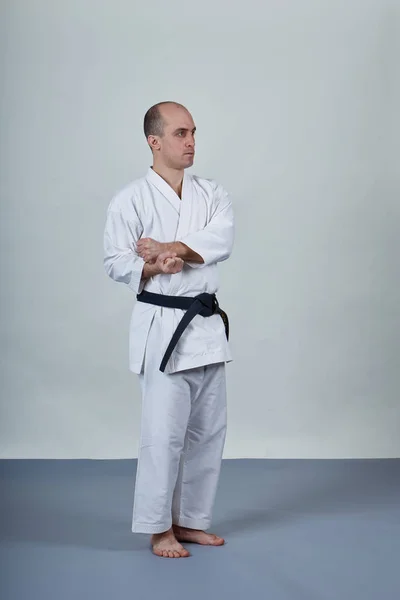 Male Athlete Doing Formal Karate Exercises Gray Cover — ストック写真